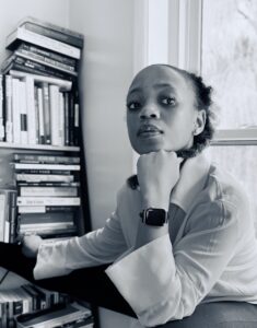 Zinhle poses at her desk in this black-and-white photograph